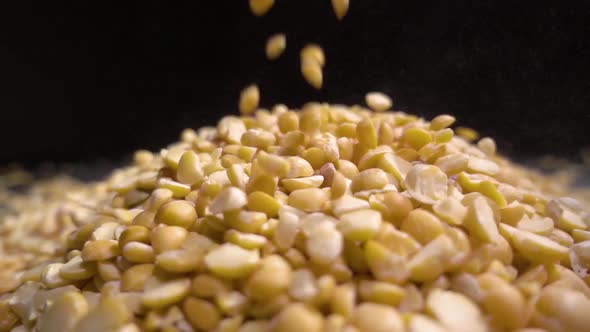 Dried Peas Are Poured on a Table, Black Background alt