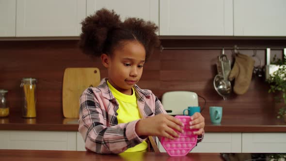 Cute School Age African American Girl Playing with Antistress Sensory Fidget Toy alt