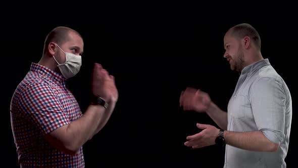 Two Guys at Social Distance Because of Coronavirus COVID-19. Isolation and Quarantine Are Over, but alt