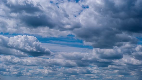 Timelapse of Layered Cumulus Clouds Moving in the Blue Sky alt
