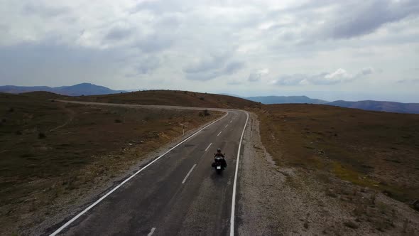 Motorbike Rider Riding in Golden Nature of Steppe Highway, Anatolia