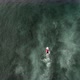 Above View of Solo Surfer Rowing Against Waves