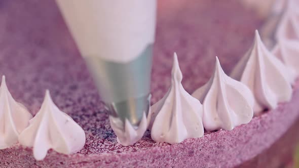 Confectioner Forms Biscuit Cake Outline with Cream Flowers alt