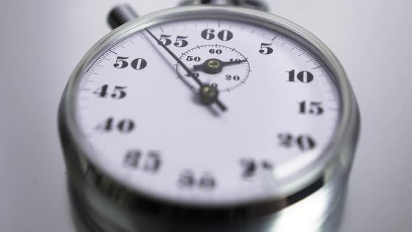 Macro shot of a classic metallic retro mechanical analog stopwatch alt