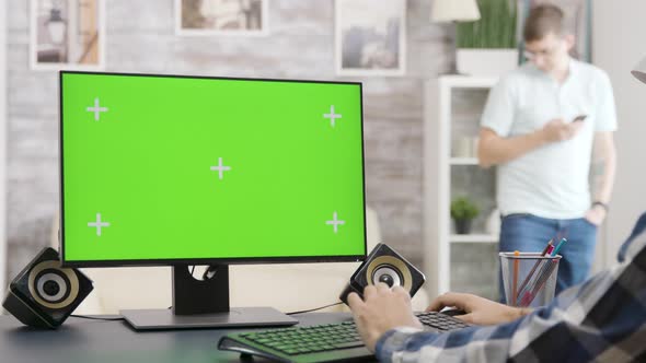 Parallax Zoom in Shot of Man Looking at Green Screen Isolated Mock-up PC Display alt