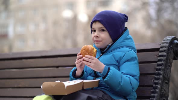 Hungry Kid Eating Double Cheeseburger Outdoor