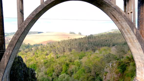 Aerial Drone Flying Back Through Gundián Viaduct spanning Ulla River In Galicia. Dolly Back alt