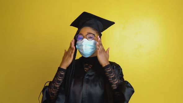 The Graduate Student in a Protective Mask Expresses with Gestures the Need to Comply with Quarantine alt
