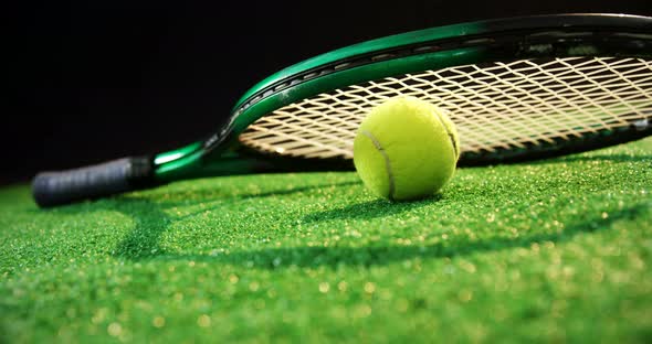Racket and tennis ball on grass 4k alt