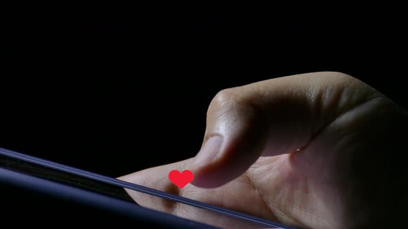 Red heart icon float on smartphone thumb finger play touch screen social network media