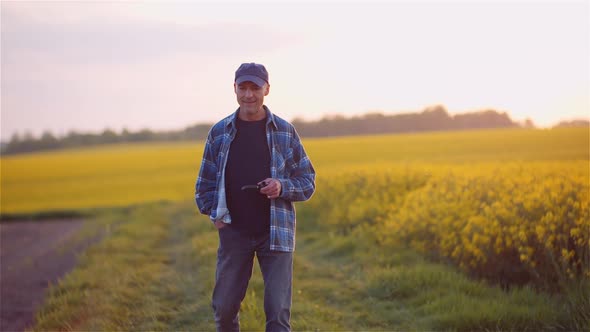 Successful Smiling Farmer Smoking His Pipe On Field Wile Examining Crops Agriculture alt