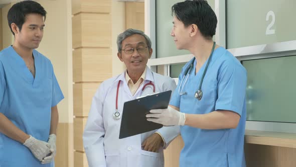 Team of asian doctor nurse consult together on patients file at hospital alt