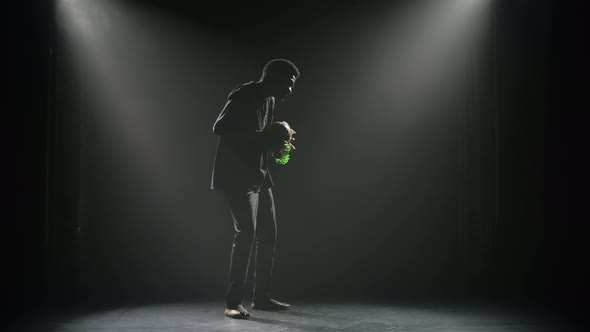 Happy Black Man Enjoys Playing an African Rhythm Instrument Shekere That Makes Rattling Sound alt