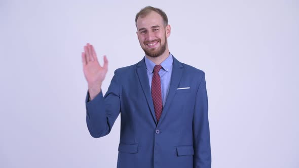 Happy Bearded Businessman in Suit Waving Hand