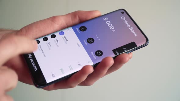 Checking bank accounts balance using the banking app on a smartphone