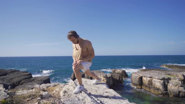 Fitness Exercises Outdoors Young Fit Man On The Beach. alt