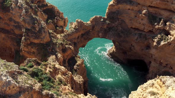 Eroded Stone Arch 'Catedral' above Algarve's Coastline sea in Lagos Portugal alt