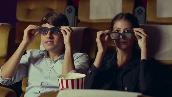 Man and Woman in the Cinema Watching a 3D Movie alt
