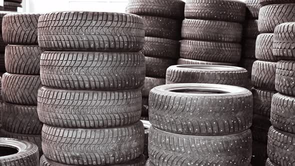 Tire stack background. car tires stacked one on top of another in a warehouse.