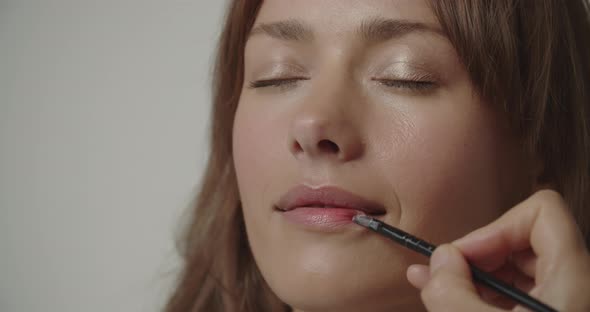 Young Woman Closing Eyes As Make Up Is Applied