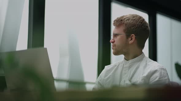 Financial Specialist or Businessman is Looking at Screen of Laptop in His Office Working and Reading alt