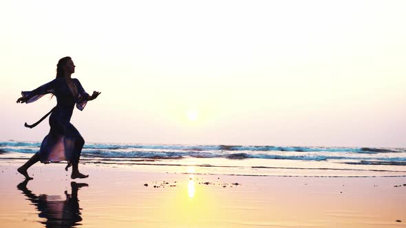 Silhouette of Young Woman Performing Grand Jete Jump on the Beach in Slow Motion