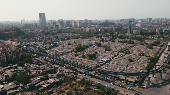 Aerial view and skyline of Mumbai city. Drone shot of MonoRail passing over slum.