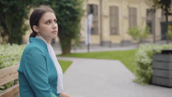 Sad Caucasian Stewardess Looking at Colleague Passing To the Background with Luggage. Jealous Slim alt