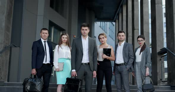 Professional Business People Group Look at Camera Standing Outside Business Center alt