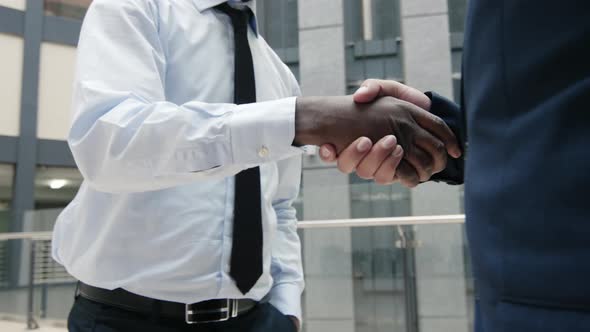 Business partners shaking hands in futuristic building