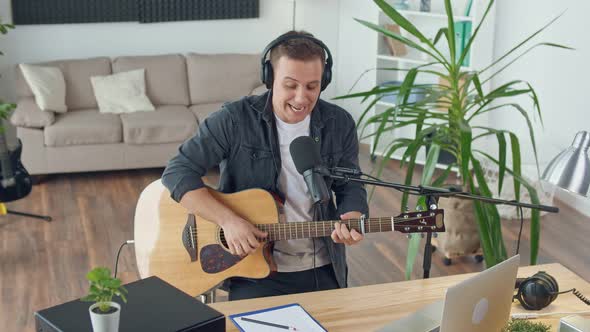 An Influential Musician With a Guitar Writes Music at Home Music Studio Spbd alt