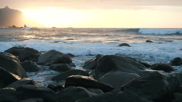Ocean Waves Crash on Rocks and Spray in Beautiful Sunset Light at Benijo Beach in Tenerife, Canary alt