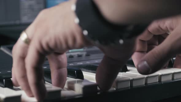Musician's hands while plays keyboards, close up 4K. alt