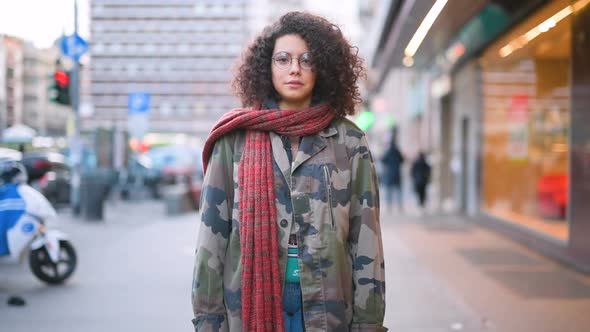 Slow motion young beautiful mixed race woman outdoor looking camera laughing alt