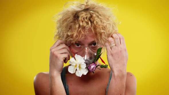 Front View Portrait of Young Caucasian Queer Man with Flowers in Nebulizer Mask alt