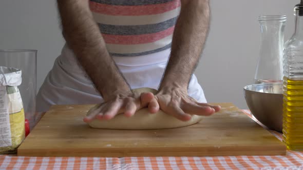 Man's hand preparing pizza dough