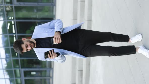 Vertical video of Gorgeous Bearded Businessman Using Mobile Phone For Texting During Way to Office