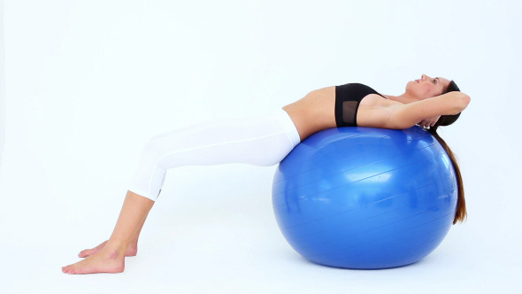 Fit Woman Doing Sit Ups On Blue Exercise Ball