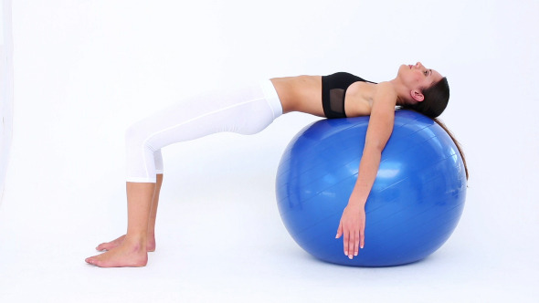 Fit Model Doing Pelvic Lifts On Blue Exercise Ball