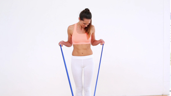 Fit Model Standing And Stretching Resistance Band