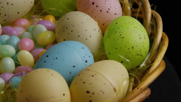 Rotating shot of Easter decorations and candy in colorful Easter grass - EASTER 064 alt