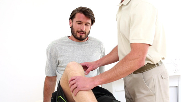 Physical Therapist Checking Patients Knee
