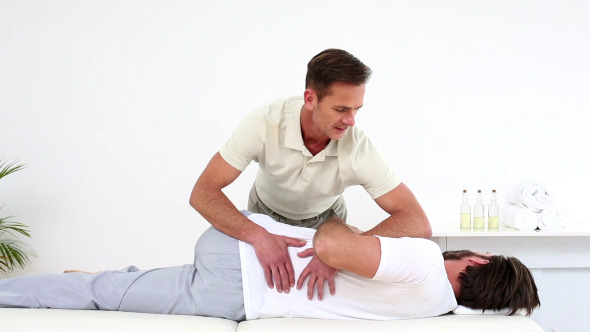 Physical Therapist Checking Patients Lower Back
