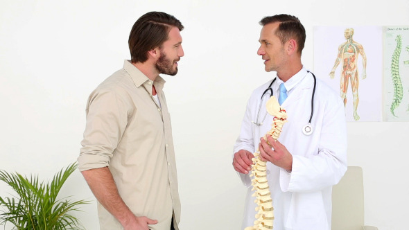 Doctor Talking With His Patient About A Skeleton