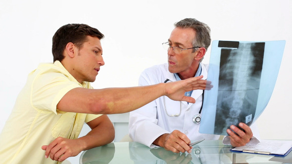 Doctor Showing Spine Xray To His Patient