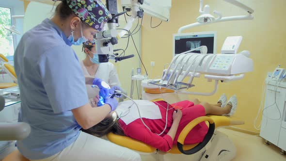 Dentist treating a patient alt