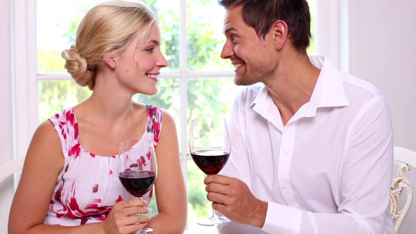 Happy Young Couple Drinking Red Wine Together