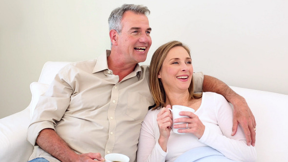 Couple Drinking Coffee On The Couch 2