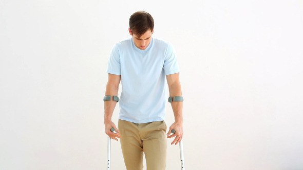 Injured Man On Crutches Stepping Towards Camera