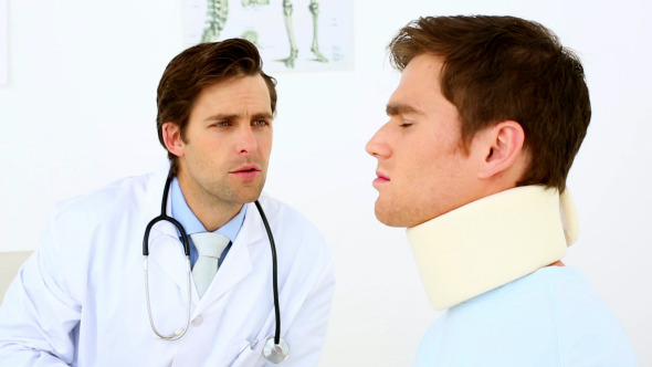 Doctor Talking To Patient With A Neck Injury